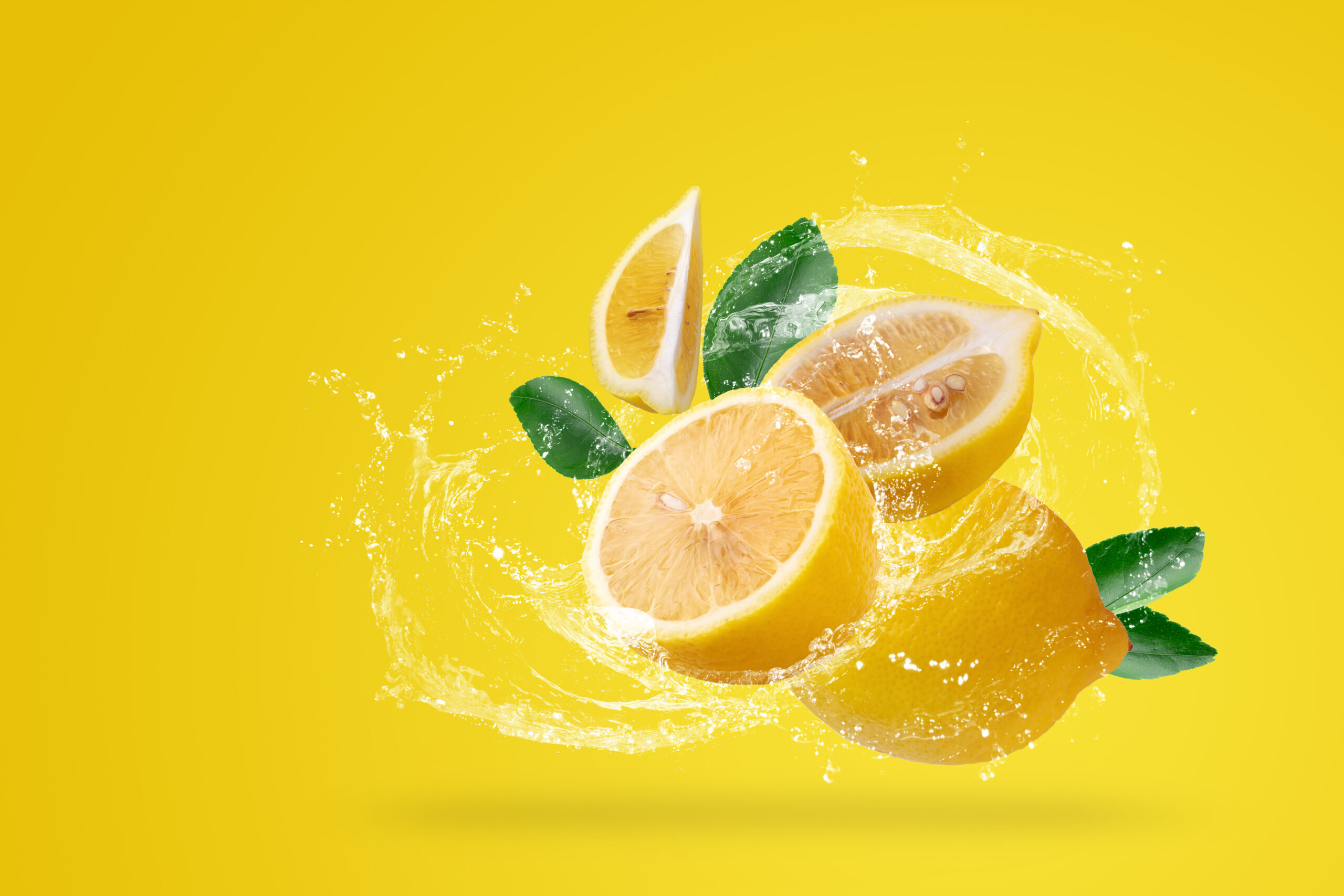 Sarı arka plan üzerinde limon üzerine su sıcraması